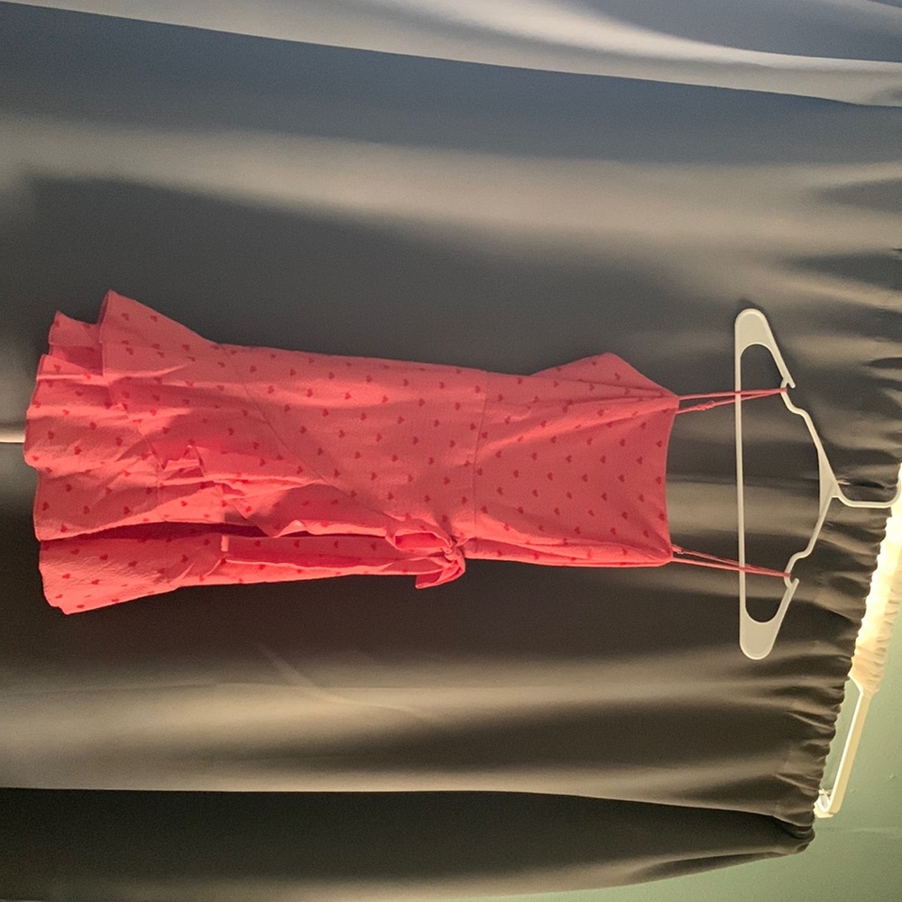 Beautiful red dress, has cute little hearts on it . Zips on the side !
